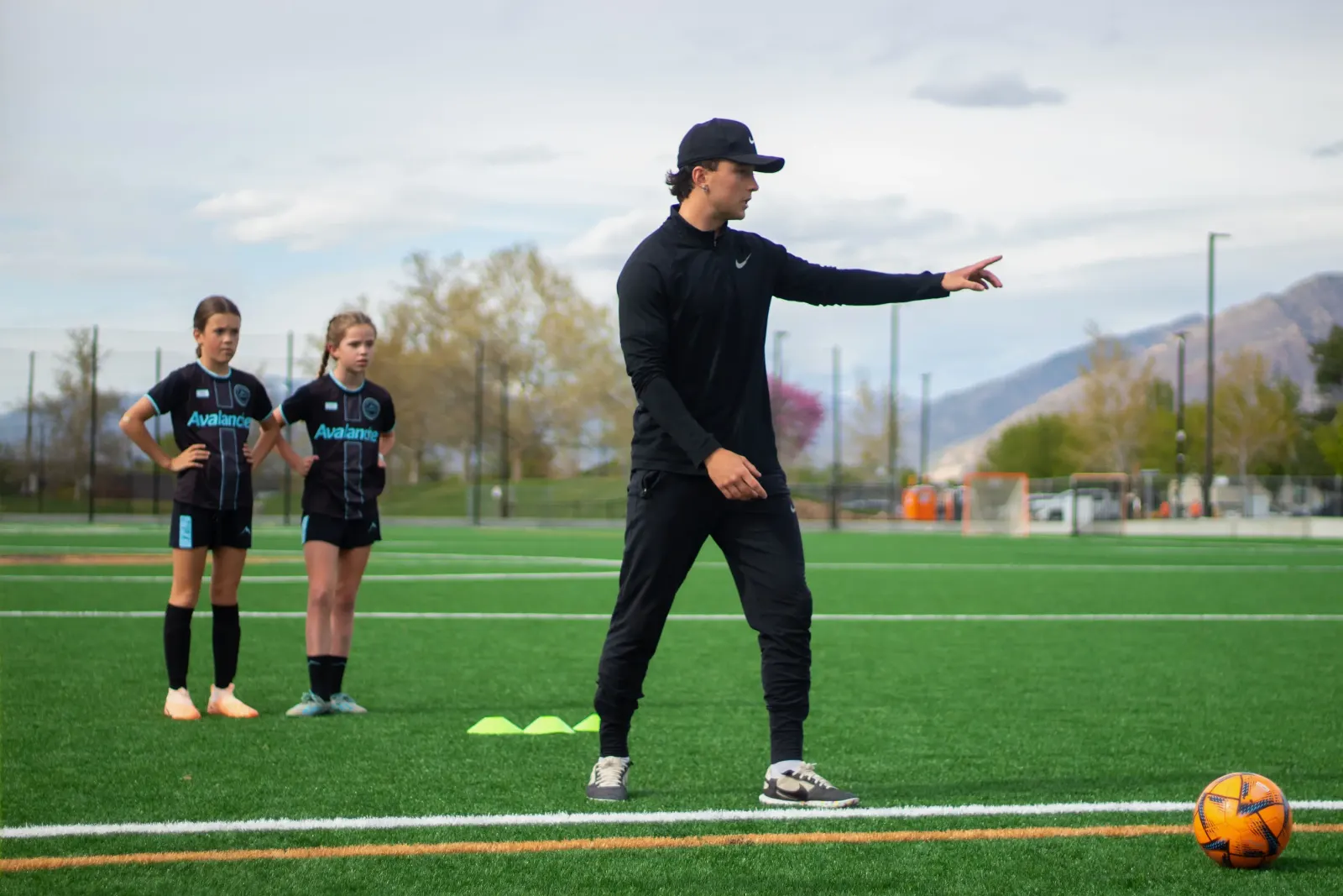 Nik coaching young soccer players on the field