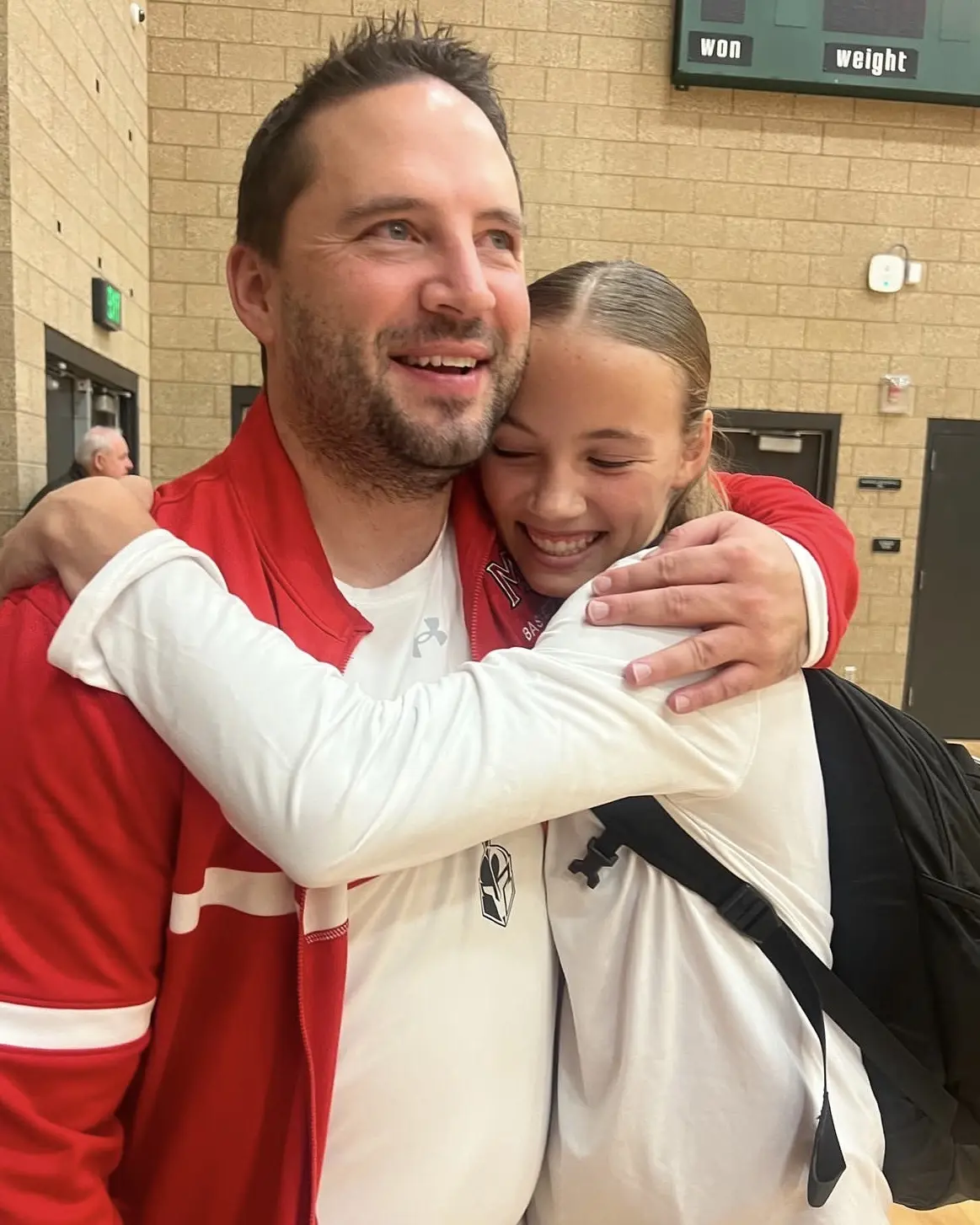 Coach Matt hugging Kaylee after a game